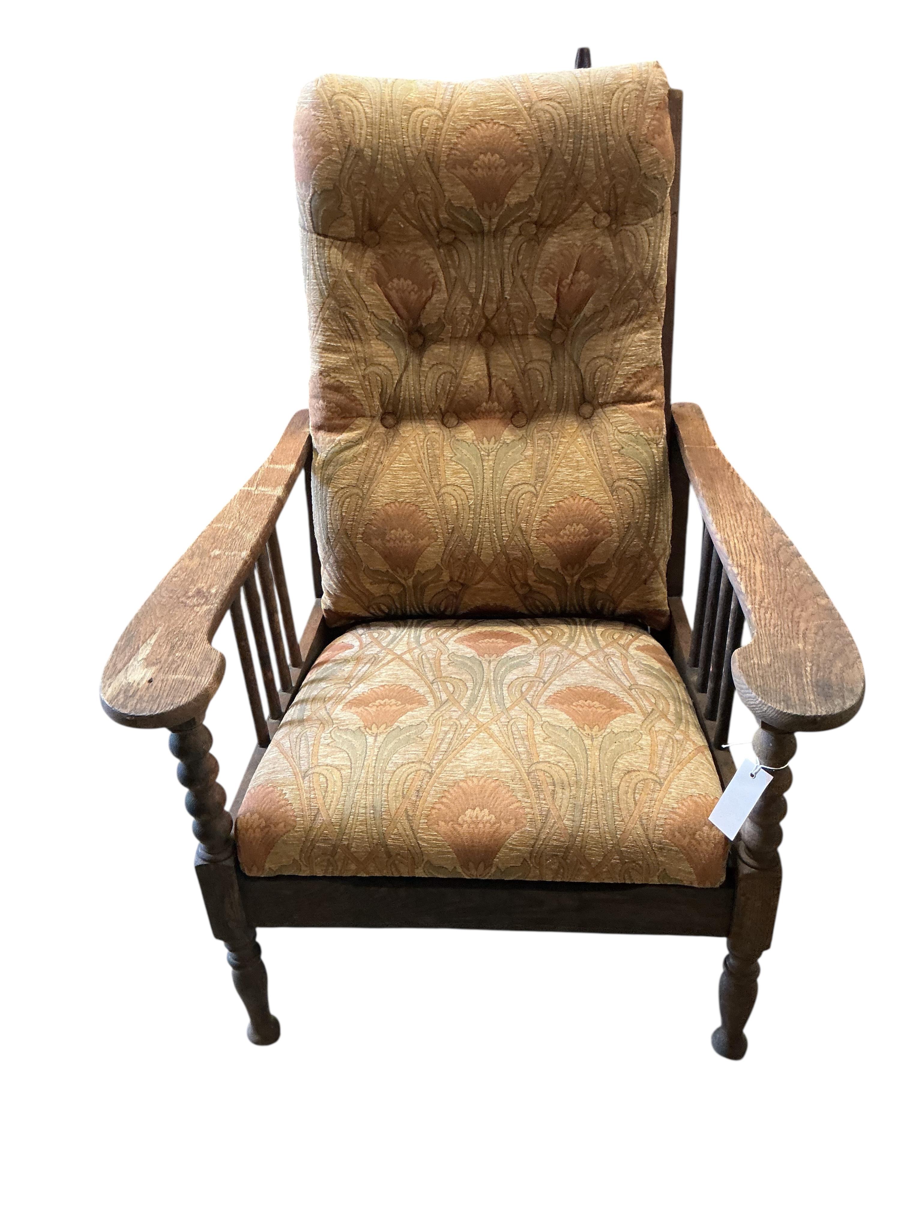 A pair of Liberty style Arts and Crafts oak reclining armchairs and an oak octagonal occasional table